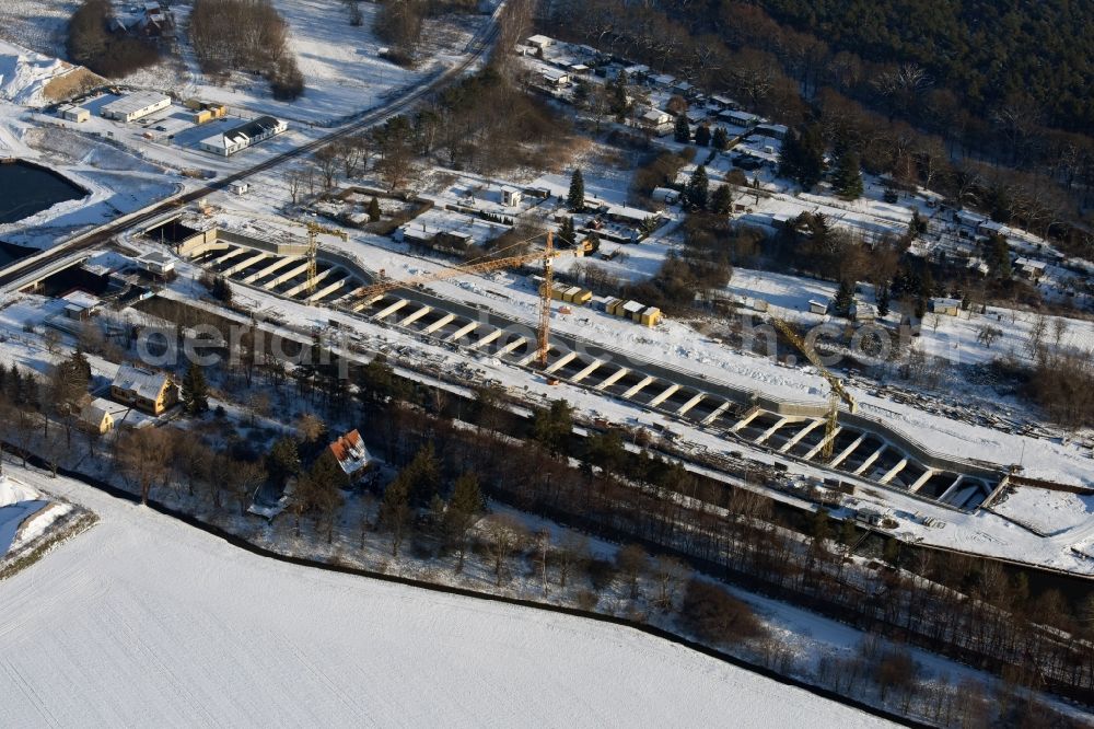 Aerial image Zerben - Wintry snowy construction site at the Zerben sluice, bridge and the riverside of the Elbe-Havel-Canel in the state Saxony-Anhalt