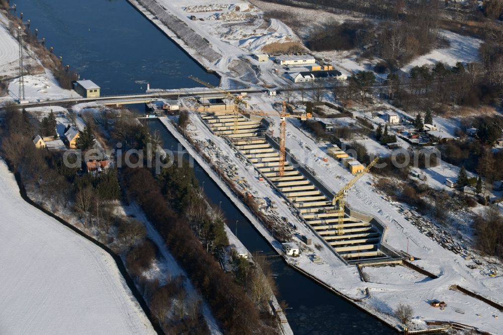 Aerial photograph Zerben - Wintry snowy construction site at the Zerben sluice, bridge and the riverside of the Elbe-Havel-Canel in the state Saxony-Anhalt