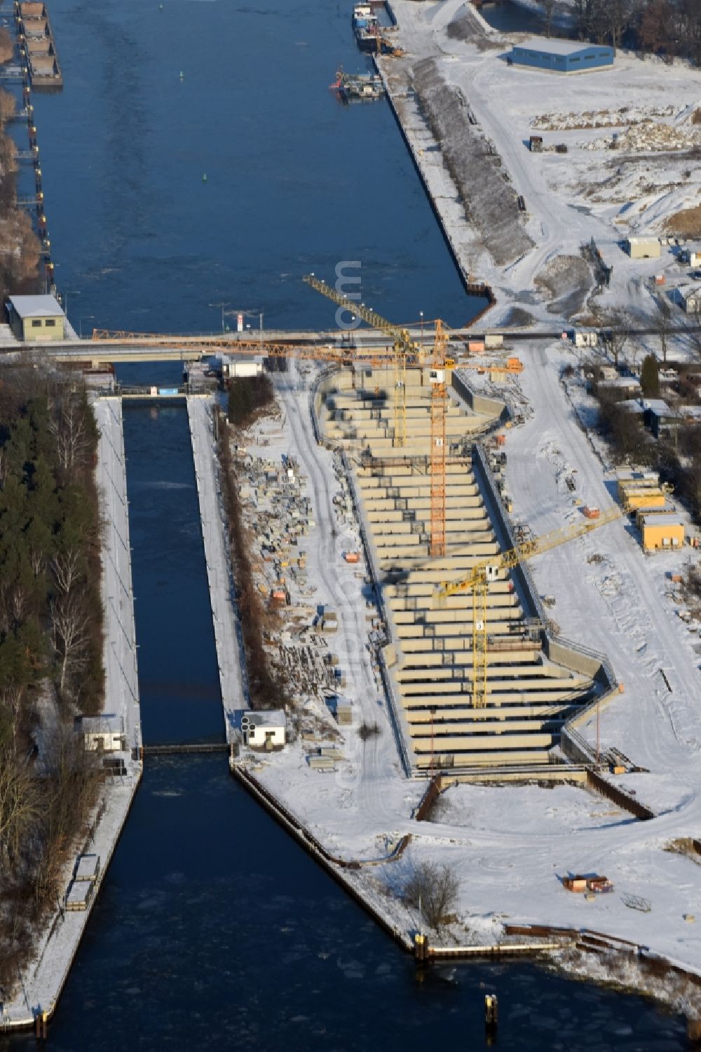 Aerial image Zerben - Wintry snowy construction site at the Zerben sluice, bridge and the riverside of the Elbe-Havel-Canel in the state Saxony-Anhalt