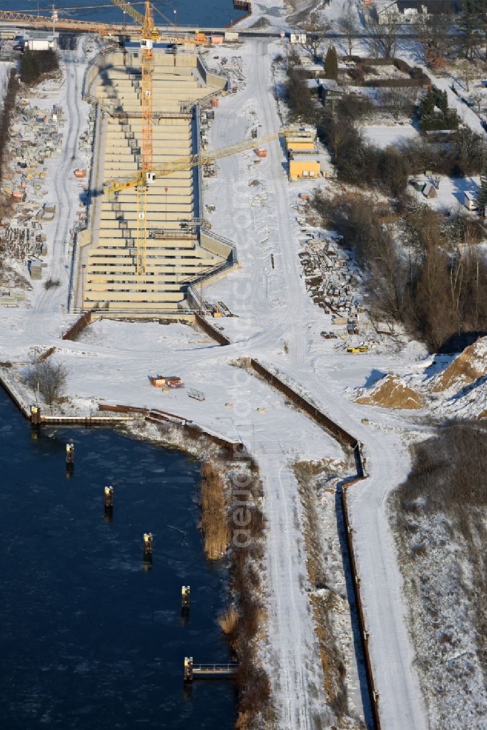 Aerial photograph Zerben - Wintry snowy construction site at the Zerben sluice, bridge and the riverside of the Elbe-Havel-Canel in the state Saxony-Anhalt