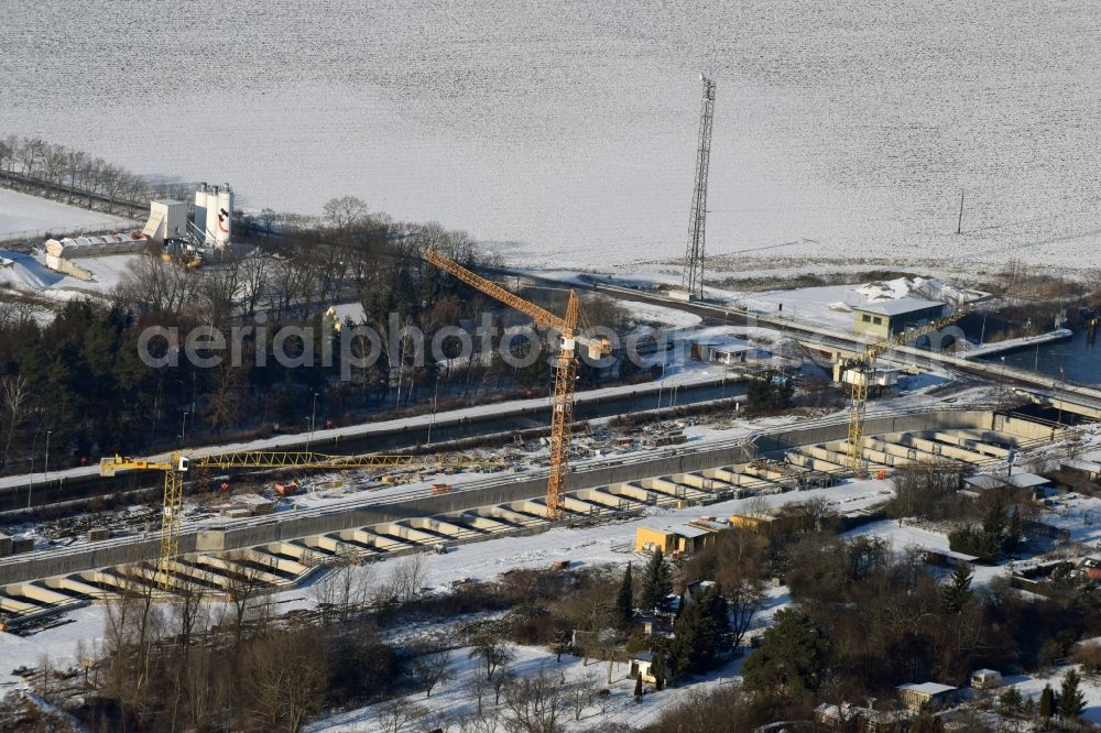 Aerial image Zerben - Wintry snowy construction site at the Zerben sluice, bridge and the riverside of the Elbe-Havel-Canel in the state Saxony-Anhalt