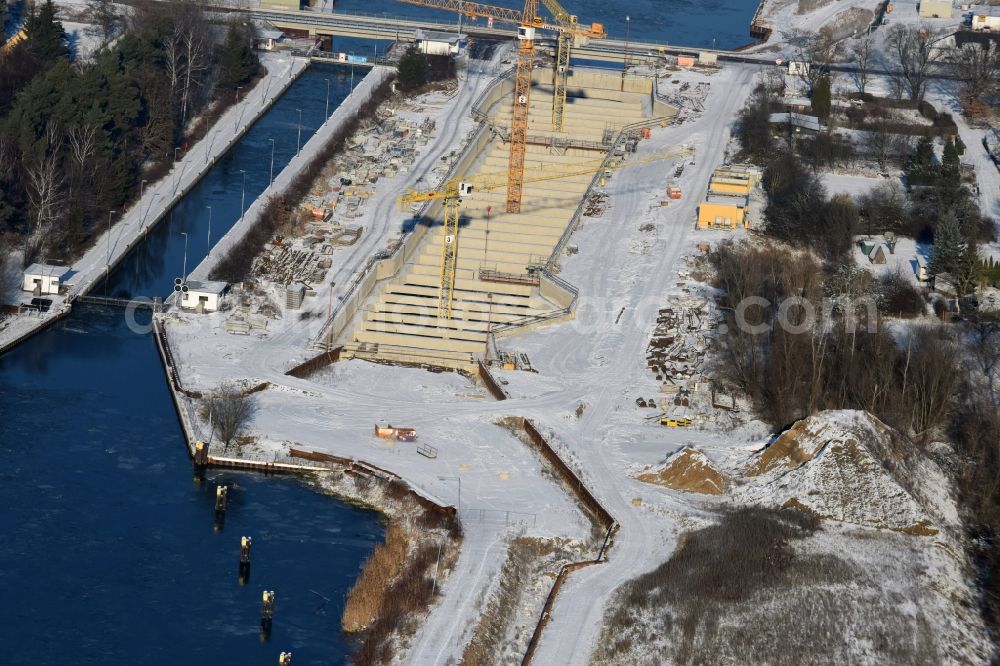 Zerben from the bird's eye view: Wintry snowy construction site at the Zerben sluice, bridge and the riverside of the Elbe-Havel-Canel in the state Saxony-Anhalt