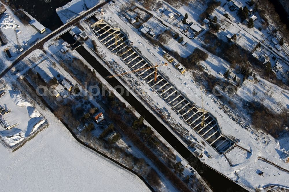 Aerial image Zerben - Wintry snowy construction site at the Zerben sluice, bridge and the riverside of the Elbe-Havel-Canel in the state Saxony-Anhalt