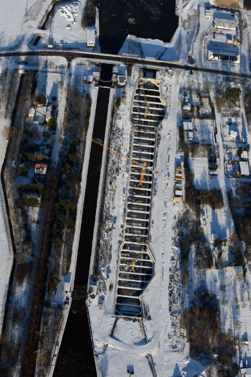 Aerial photograph Zerben - Wintry snowy construction site at the Zerben sluice, bridge and the riverside of the Elbe-Havel-Canel in the state Saxony-Anhalt