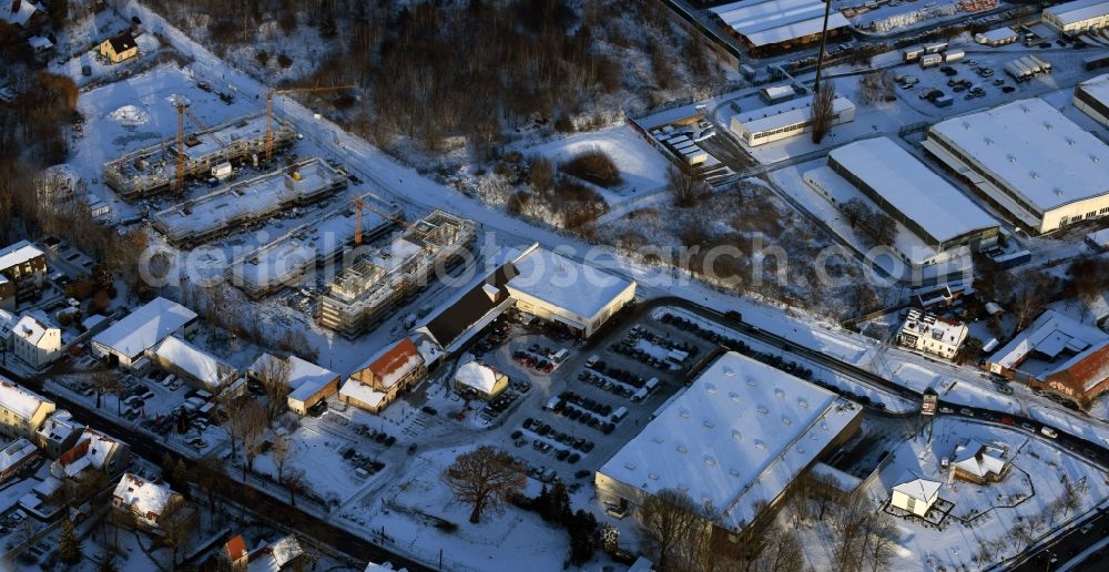 Berlin from above - Wintry snowy construction site to build a new multi-family residential complex An der Schule destrict Mahlsdorf in Berlin