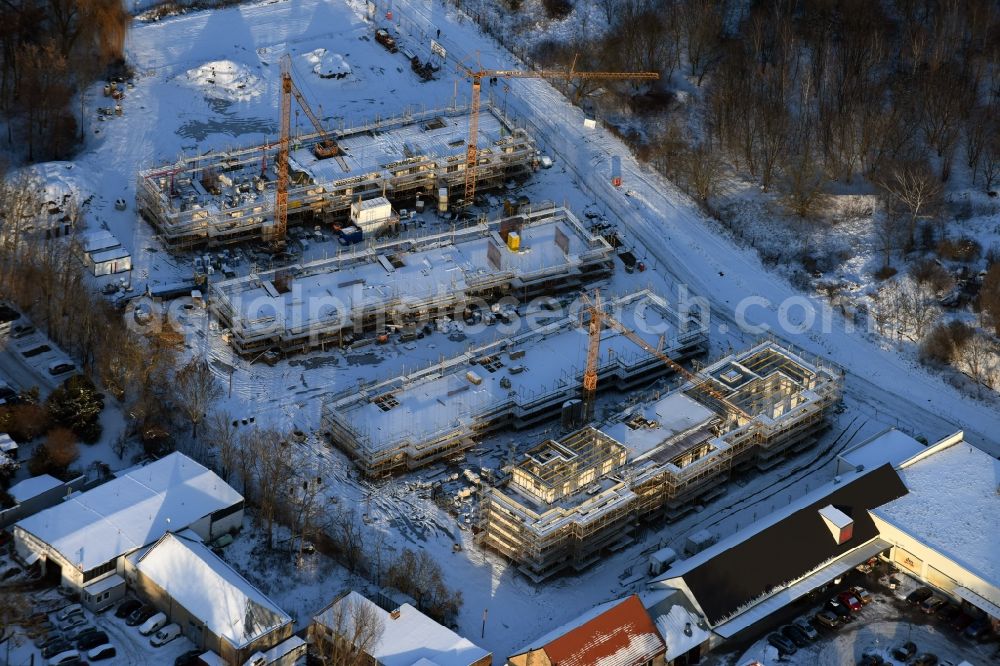 Aerial image Berlin - Wintry snowy construction site to build a new multi-family residential complex An der Schule destrict Mahlsdorf in Berlin