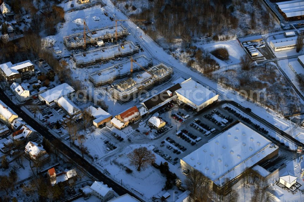 Aerial photograph Berlin - Wintry snowy construction site to build a new multi-family residential complex An der Schule destrict Mahlsdorf in Berlin