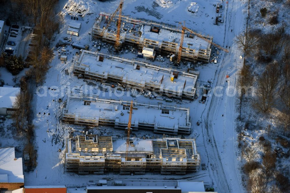 Aerial image Berlin - Wintry snowy construction site to build a new multi-family residential complex An der Schule destrict Mahlsdorf in Berlin