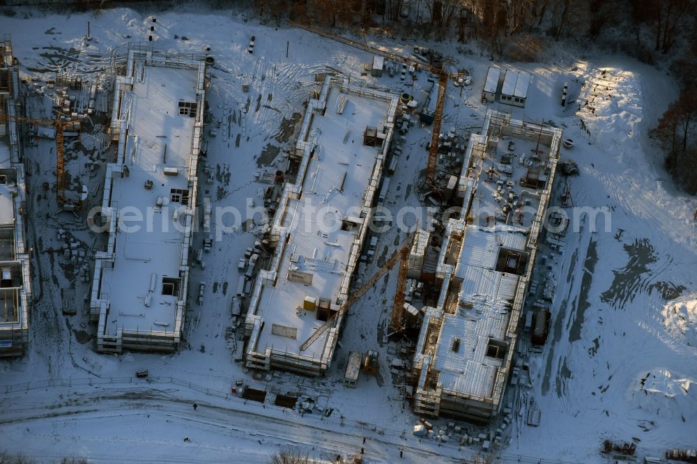 Aerial photograph Berlin - Wintry snowy construction site to build a new multi-family residential complex An der Schule destrict Mahlsdorf in Berlin