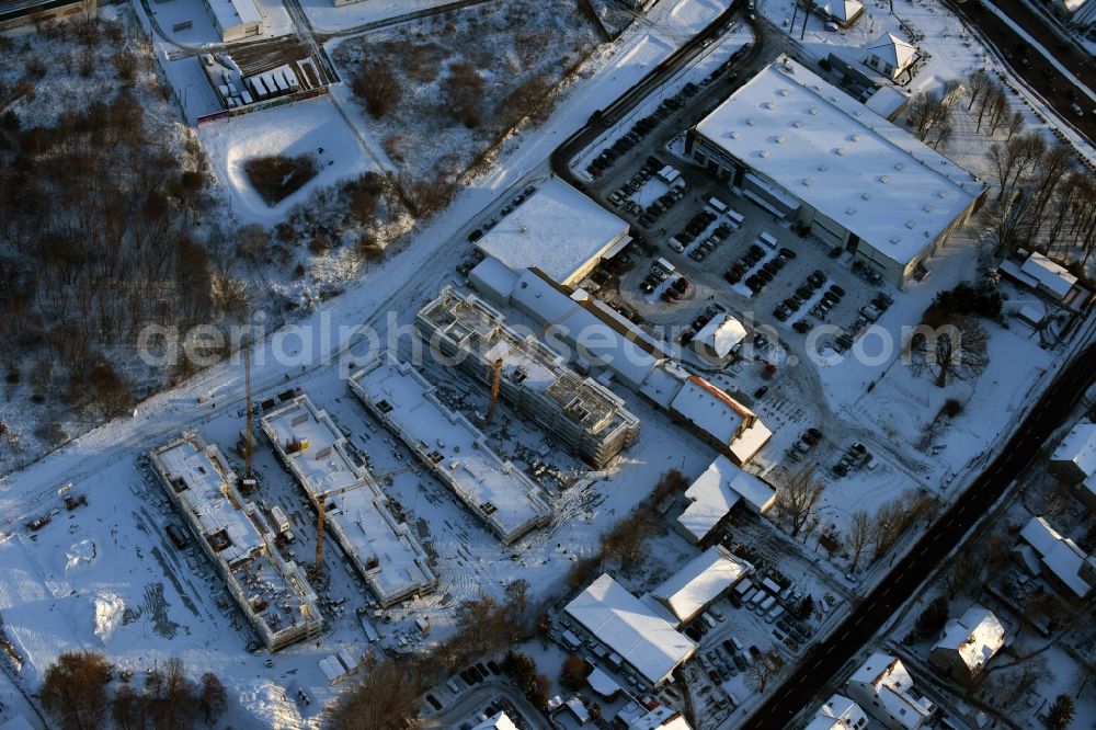 Aerial image Berlin - Wintry snowy construction site to build a new multi-family residential complex An der Schule destrict Mahlsdorf in Berlin