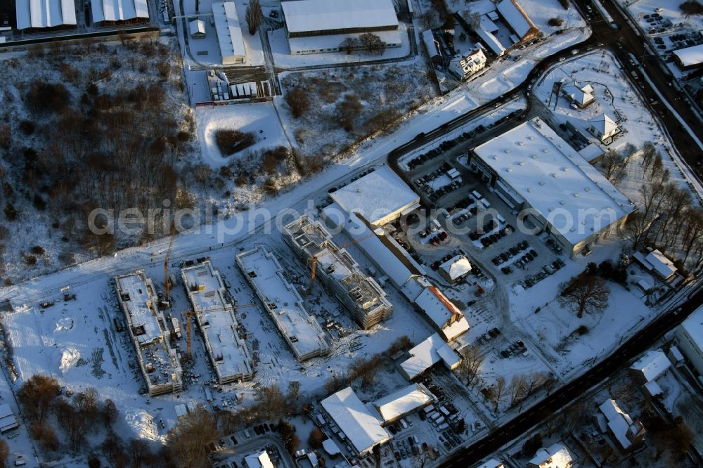 Aerial photograph Berlin - Wintry snowy construction site to build a new multi-family residential complex An der Schule destrict Mahlsdorf in Berlin