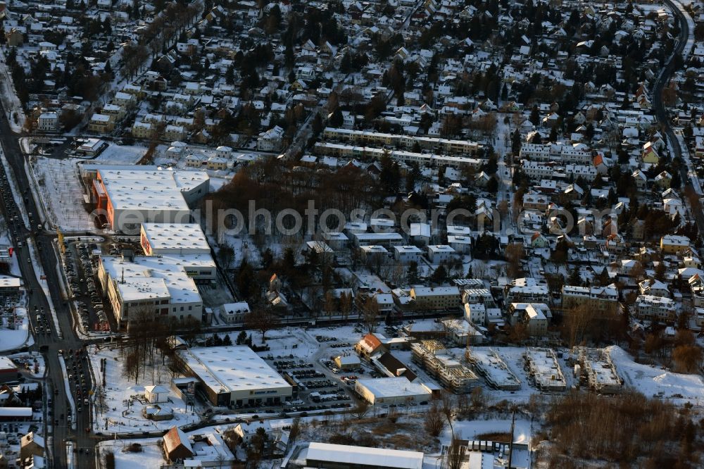 Berlin from above - Wintry snowy construction site to build a new multi-family residential complex An der Schule destrict Mahlsdorf in Berlin