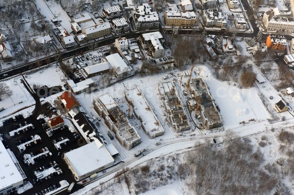 Aerial image Berlin - Wintry snowy construction site to build a new multi-family residential complex An der Schule destrict Mahlsdorf in Berlin