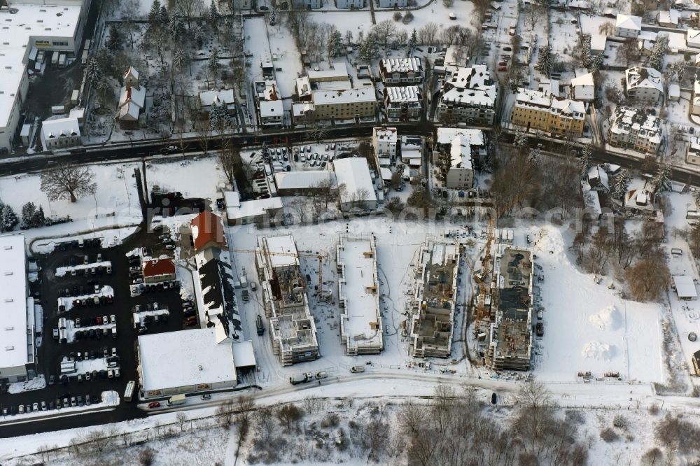 Aerial photograph Berlin - Wintry snowy construction site to build a new multi-family residential complex An der Schule destrict Mahlsdorf in Berlin