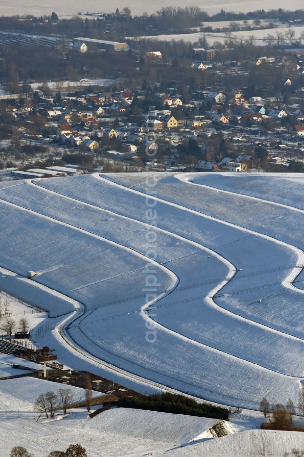 Magdeburg from above - Wintry snowy piled landfill mountain of Solar Park Magdeburg in Saxony-Anhalt. Under the direction of the WSB Group of Companies of Magdeburg solar park was built on the former landfill site Cracauer Anger