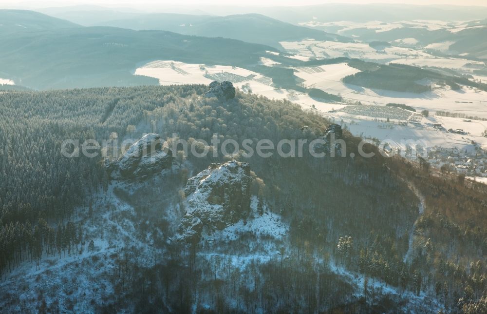 Aerial image Olsberg - Wintry snowy rock formation Bruchhauser stones near Brilon in the state of North Rhine-Westphalia. The known archaeological site is located in a conservation area of the Rothaargebirge