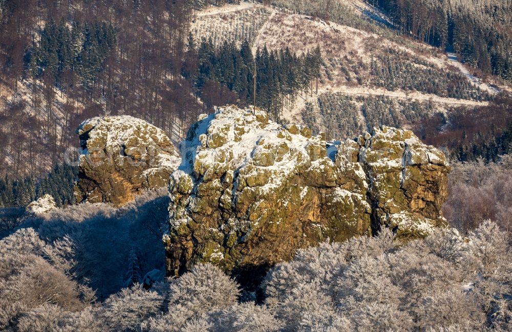 Olsberg from above - Wintry snowy rock formation Bruchhauser stones near Brilon in the state of North Rhine-Westphalia. The known archaeological site is located in a conservation area of the Rothaargebirge