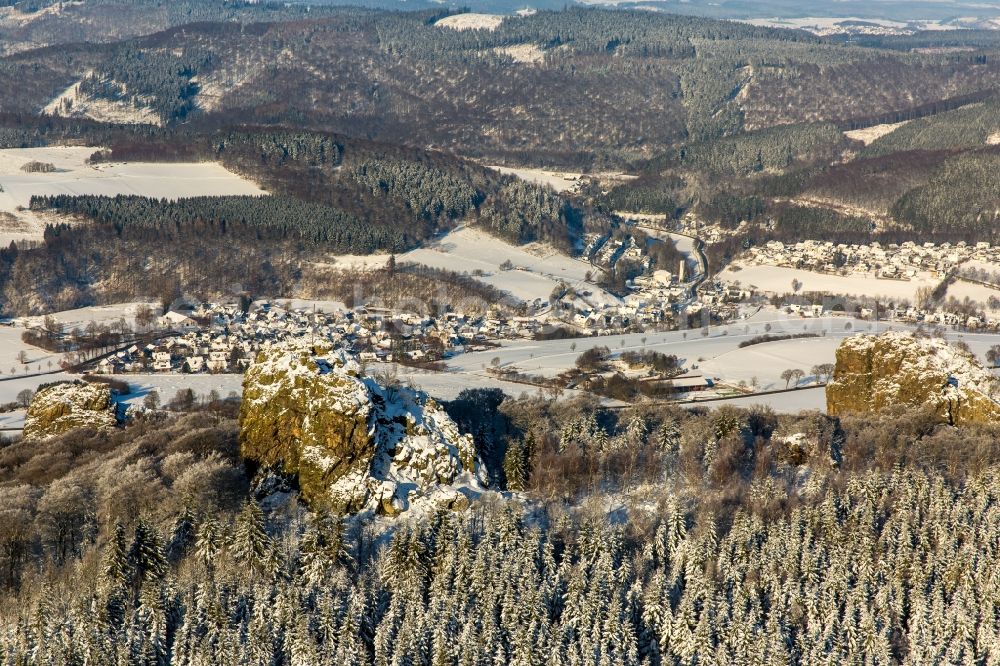 Aerial photograph Olsberg - Wintry snowy rock formation Bruchhauser stones near Brilon in the state of North Rhine-Westphalia. The known archaeological site is located in a conservation area of the Rothaargebirge