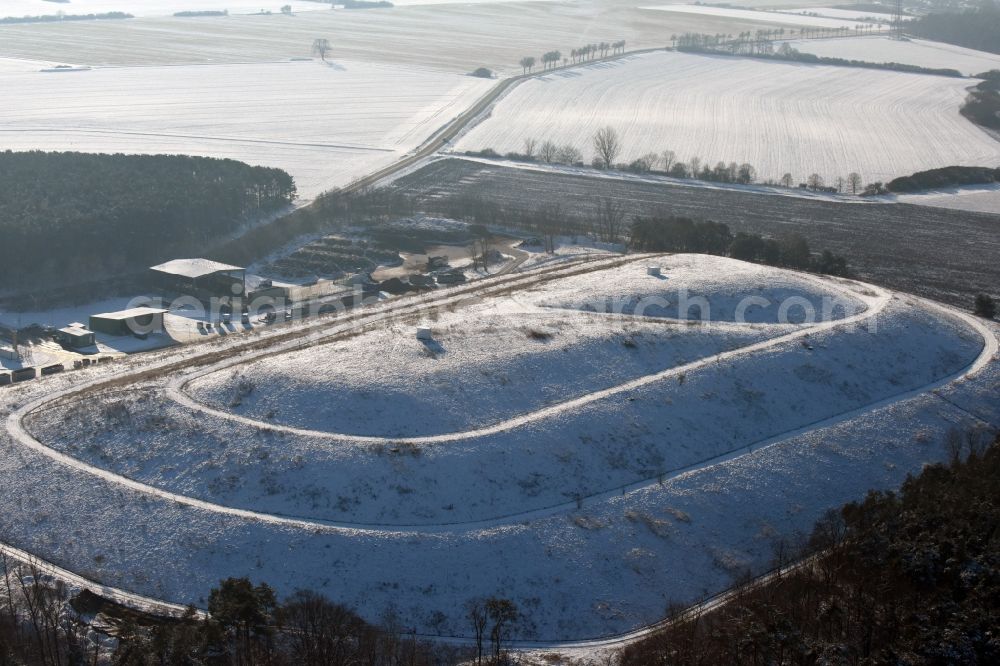 Elbe-Parey from the bird's eye view: Wintry snow-covered site of the heaped landfill Werderberg in Elbe-Parey in the state of Saxony-Anhalt. The landfill is part of Abfallwirtschaftsgesellschaft Jerichower Land mbH (the county waste management company) and is located between Elbe-Parey and the village of Bergzow