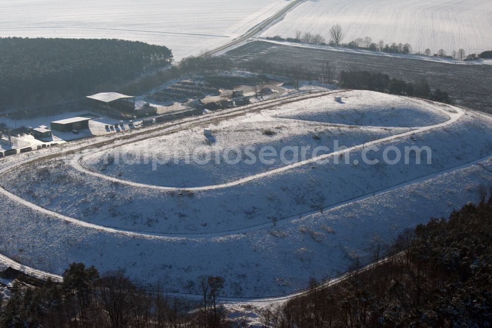 Aerial image Elbe-Parey - Wintry snow-covered site of the heaped landfill Werderberg in Elbe-Parey in the state of Saxony-Anhalt. The landfill is part of Abfallwirtschaftsgesellschaft Jerichower Land mbH (the county waste management company) and is located between Elbe-Parey and the village of Bergzow