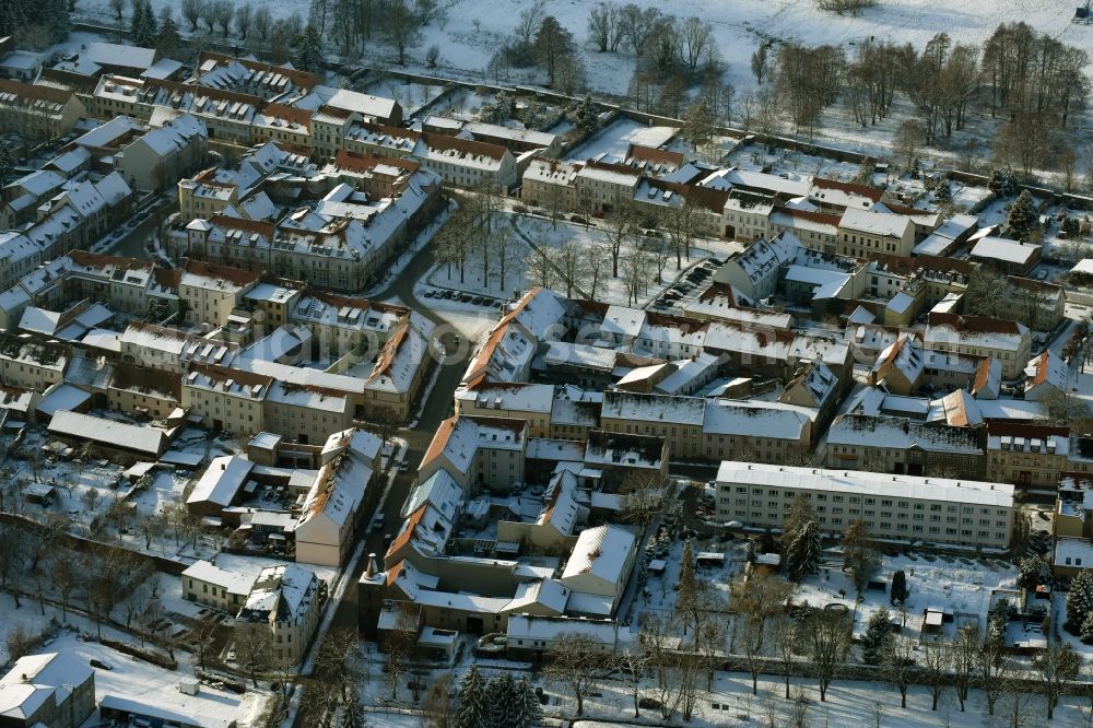 Altlandsberg from above - Wintry snowy townscape with streets and houses of the residential areas in Altlandsberg in the state Brandenburg