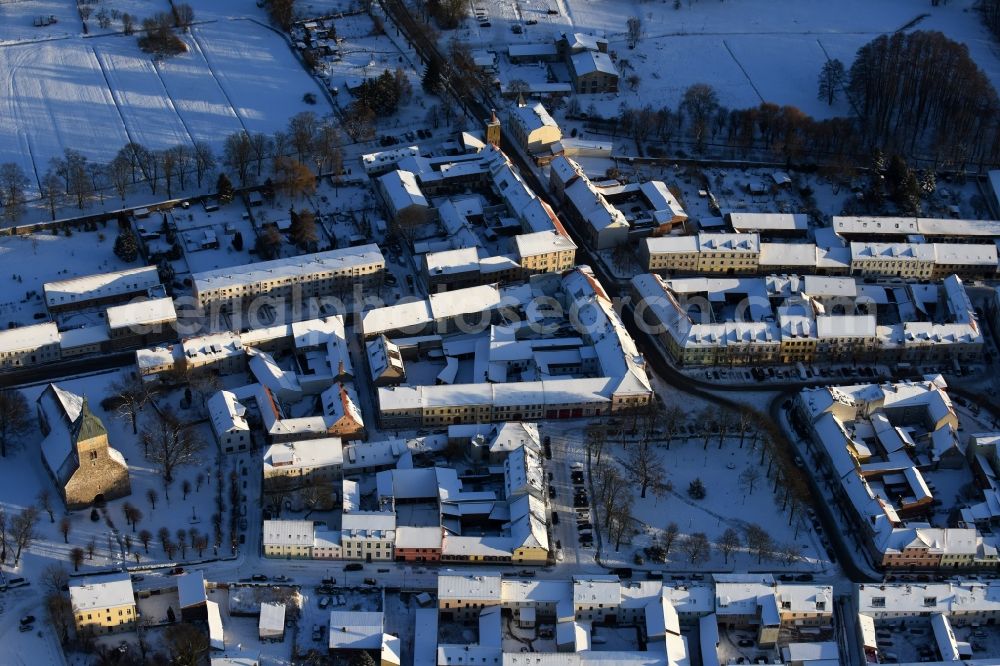 Altlandsberg from the bird's eye view: Wintry snowy Town View of the streets and houses of the residential areas in Altlandsberg in the state Brandenburg