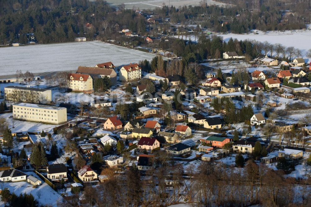 Beetzsee from the bird's eye view: Wintry snowy townscape with streets and houses of the residential areas in Beetzsee in the state Brandenburg