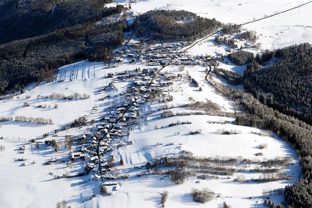 Oberweißbach/Thüringer Wald from the bird's eye view: Wintry snowy townscape with streets and houses of the residential areas in Oberweissbach/Thueringer Wald in the state Thuringia