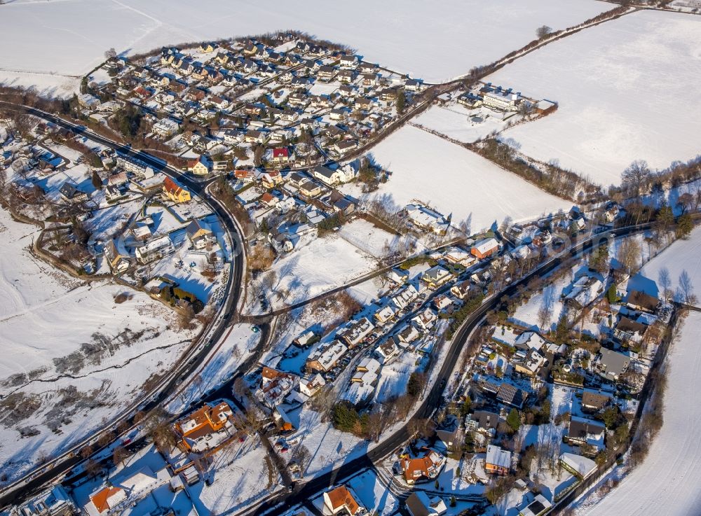 Möhnesee from above - Wintry snowy townscape with streets and houses of the residential areas in the district Delecke in Moehnesee in the state North Rhine-Westphalia