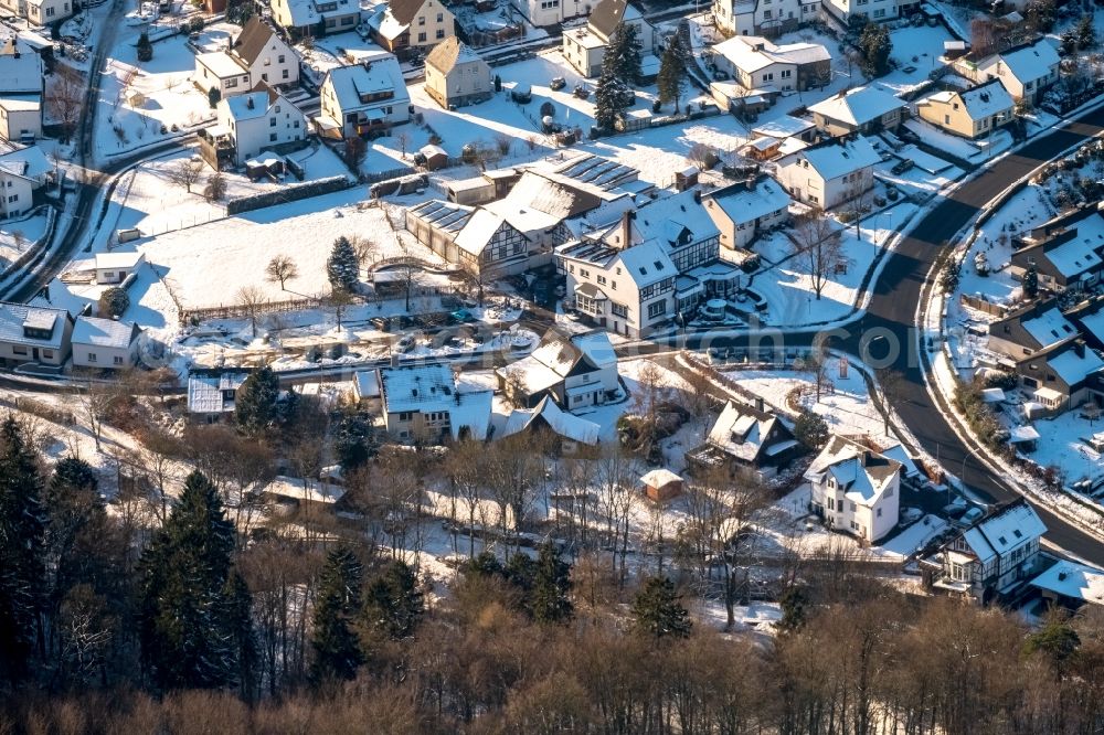 Arnsberg from above - Wintry snowy townscape with streets and houses of the residential areas in the district Rumbeck in Arnsberg in the state North Rhine-Westphalia