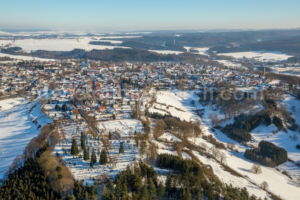 Rüthen from the bird's eye view: Wintry snowy townscape with streets and houses of the residential areas in Ruethen in the state North Rhine-Westphalia