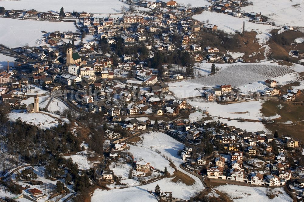 Völs am Schlern - Fié allo Sciliar from above - Wintry snowy townscape with streets and houses of the residential areas in Voels am Schlern - Fie allo Sciliar in Trentino-Alto Adige, Italy