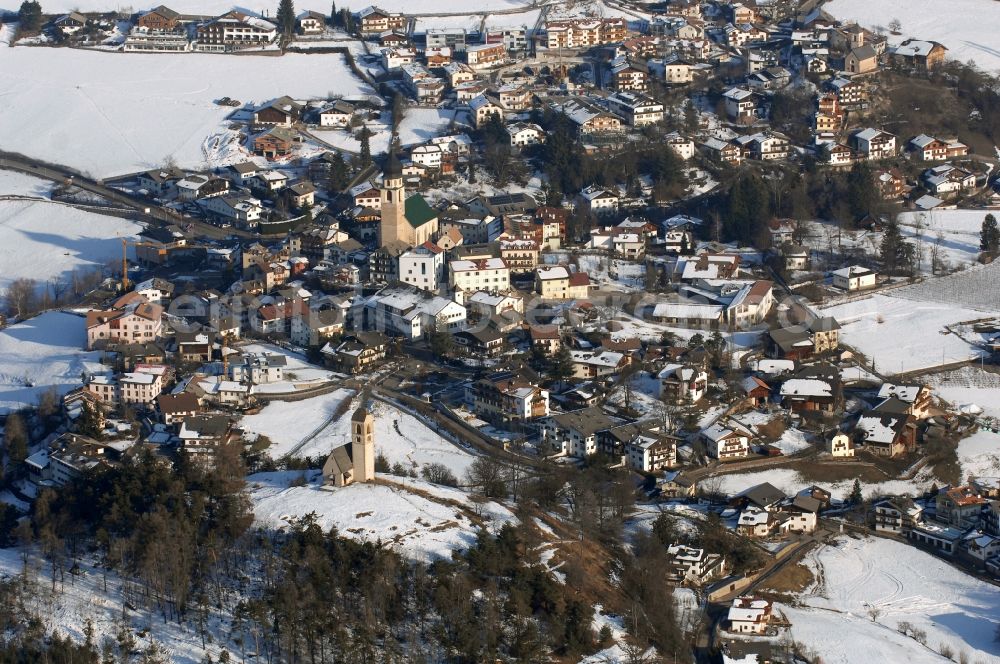 Aerial image Völs am Schlern - Fié allo Sciliar - Wintry snowy townscape with streets and houses of the residential areas in Voels am Schlern - Fie allo Sciliar in Trentino-Alto Adige, Italy