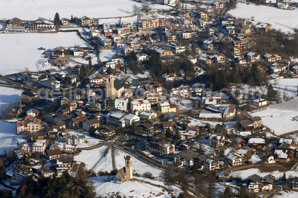 Aerial image Völs am Schlern - Fié allo Sciliar - Wintry snowy townscape with streets and houses of the residential areas in Voels am Schlern - Fie allo Sciliar in Trentino-Alto Adige, Italy