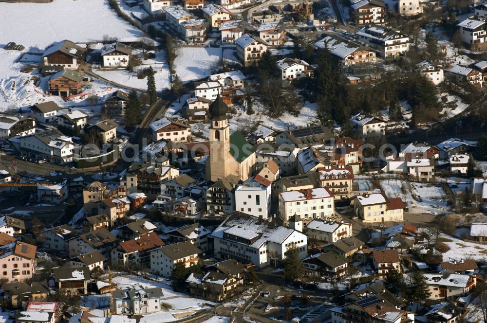 Aerial photograph Völs am Schlern - Fié allo Sciliar - Wintry snowy townscape with streets and houses of the residential areas in Voels am Schlern - Fie allo Sciliar in Trentino-Alto Adige, Italy