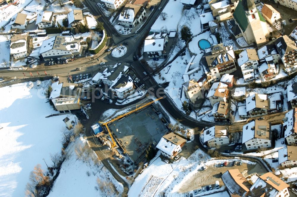 Aerial image Völs am Schlern - Fié allo Sciliar - Wintry snowy townscape with streets and houses of the residential areas in Voels am Schlern - Fie allo Sciliar in Trentino-Alto Adige, Italy