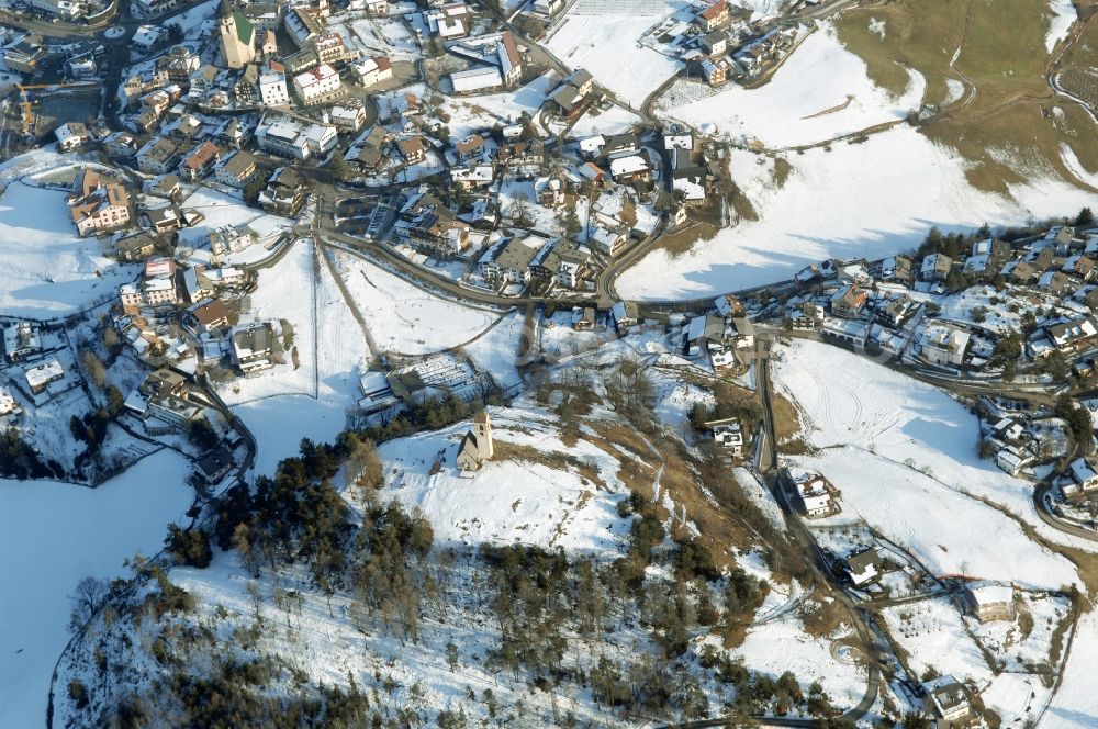 Aerial image Völs am Schlern - Fié allo Sciliar - Wintry snowy townscape with streets and houses of the residential areas in Voels am Schlern - Fie allo Sciliar in Trentino-Alto Adige, Italy