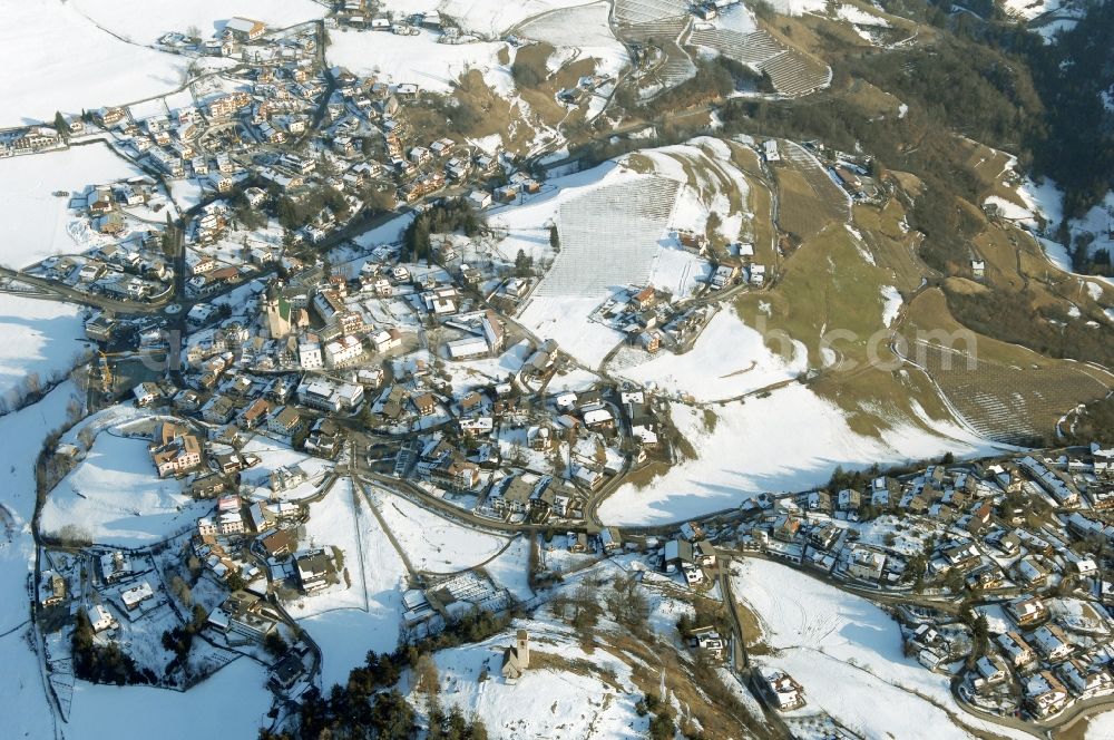 Aerial image Völs am Schlern - Fié allo Sciliar - Wintry snowy townscape with streets and houses of the residential areas in Voels am Schlern - Fie allo Sciliar in Trentino-Alto Adige, Italy