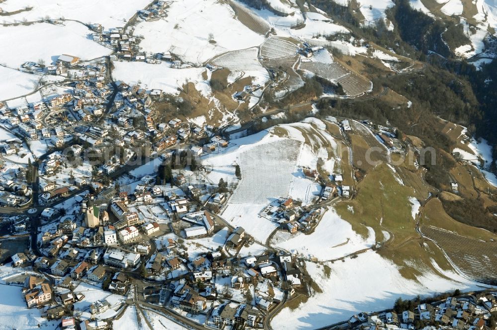 Aerial photograph Völs am Schlern - Fié allo Sciliar - Wintry snowy townscape with streets and houses of the residential areas in Voels am Schlern - Fie allo Sciliar in Trentino-Alto Adige, Italy