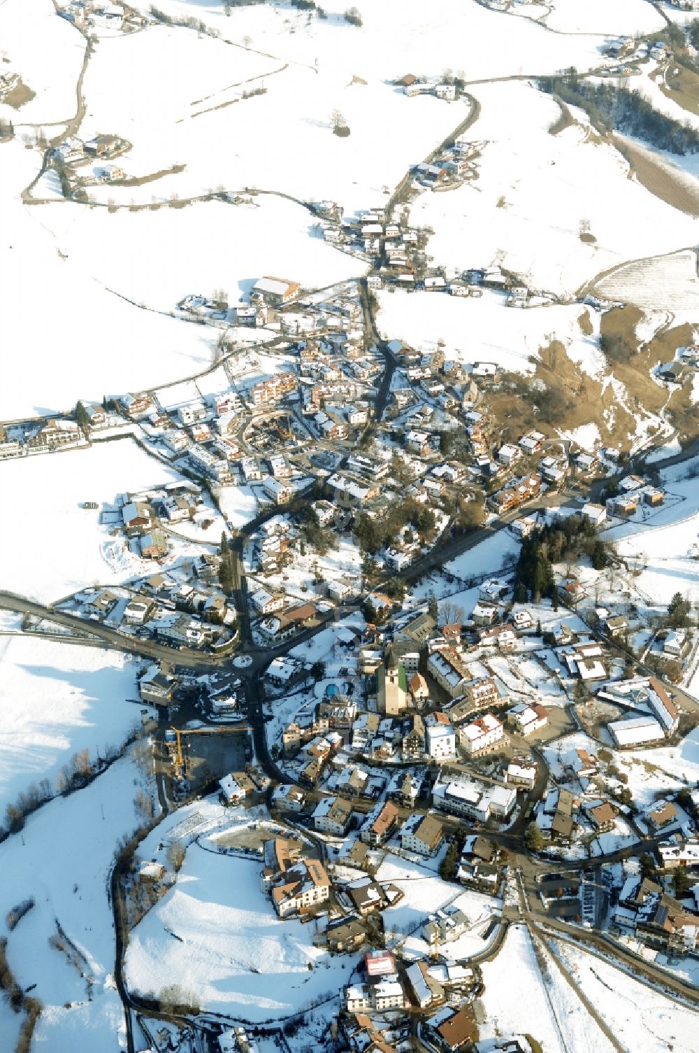 Völs am Schlern - Fié allo Sciliar from above - Wintry snowy townscape with streets and houses of the residential areas in Voels am Schlern - Fie allo Sciliar in Trentino-Alto Adige, Italy