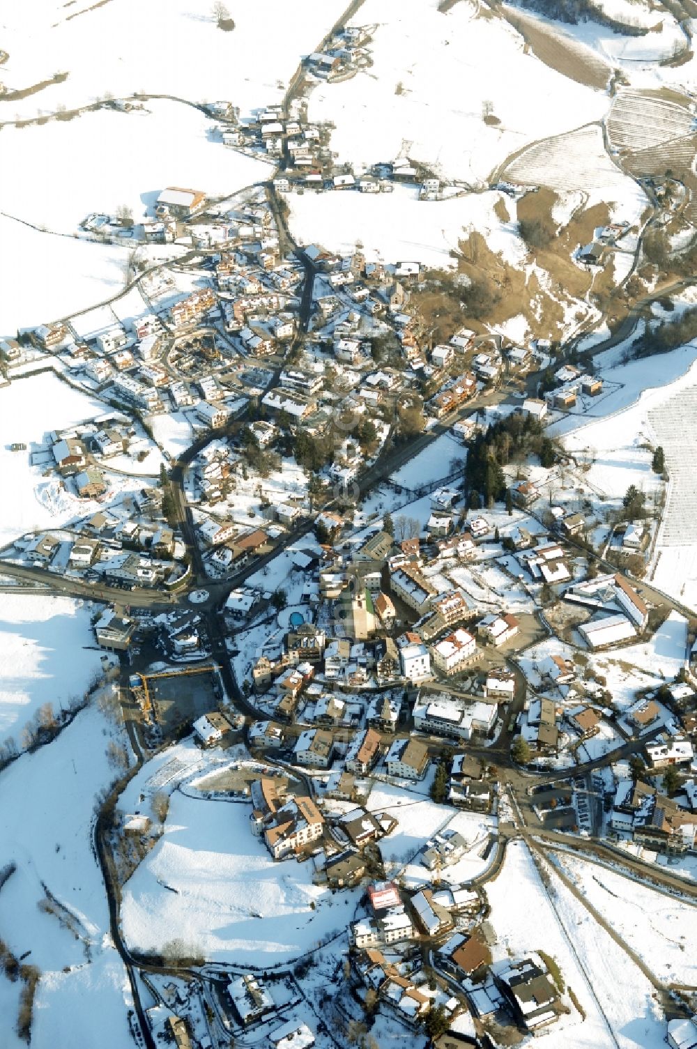 Aerial image Völs am Schlern - Fié allo Sciliar - Wintry snowy townscape with streets and houses of the residential areas in Voels am Schlern - Fie allo Sciliar in Trentino-Alto Adige, Italy