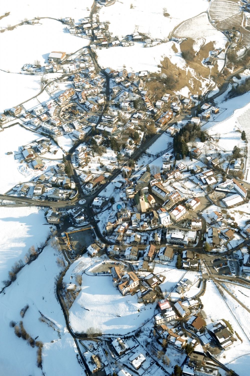 Aerial photograph Völs am Schlern - Fié allo Sciliar - Wintry snowy townscape with streets and houses of the residential areas in Voels am Schlern - Fie allo Sciliar in Trentino-Alto Adige, Italy