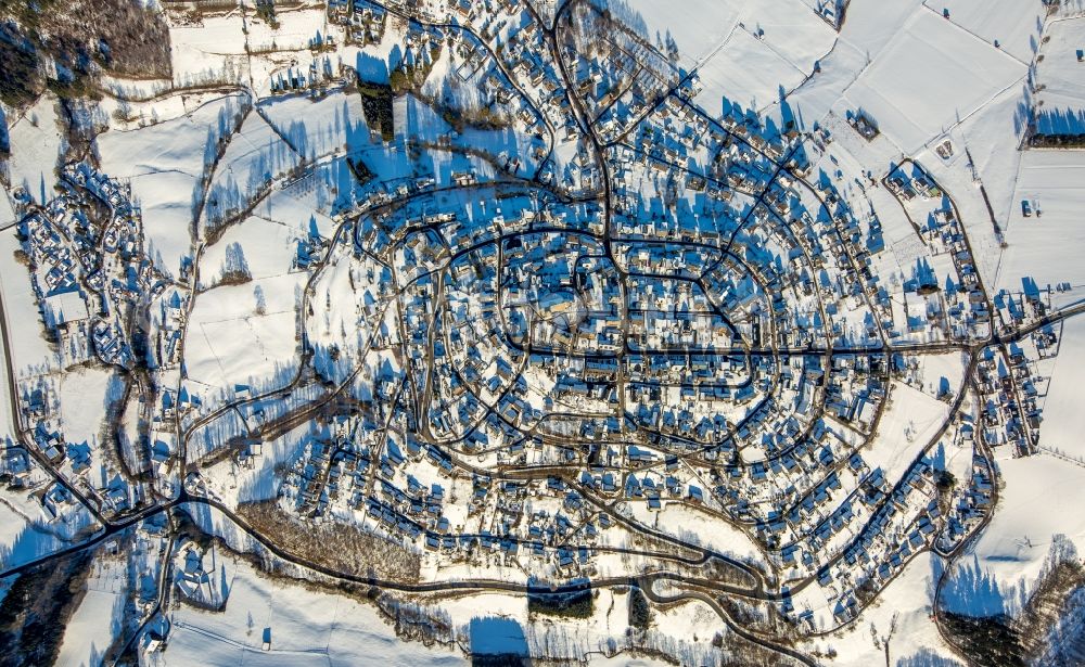 Aerial image Warstein - Wintry snowy townscape with streets and houses of the residential areas in Warstein in the state North Rhine-Westphalia