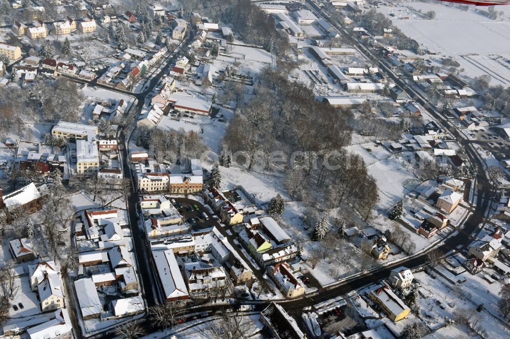 Aerial image Werneuchen - Wintry snowy townscape with streets and houses of the residential areas in Werneuchen in the state Brandenburg