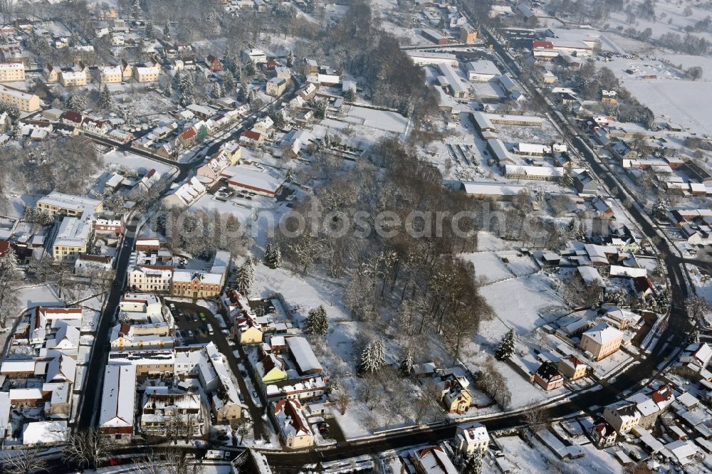 Aerial photograph Werneuchen - Wintry snowy townscape with streets and houses of the residential areas in Werneuchen in the state Brandenburg