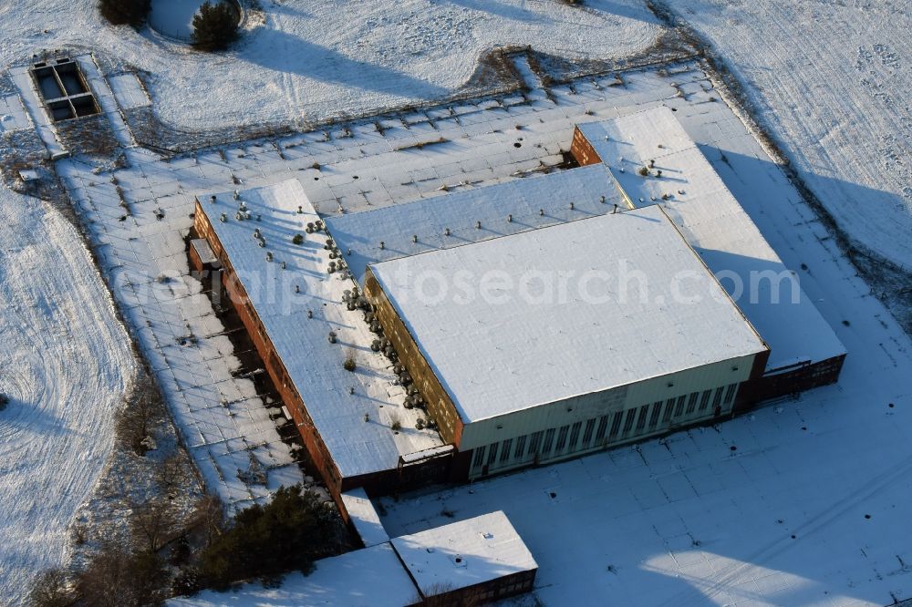 Aerial photograph Brandenburg an der Havel - Winterly snowy ruins of the former airfield hangar of the former airfield Brandenburg-Briest in Brandenburg an der Havel in the state Brandenburg