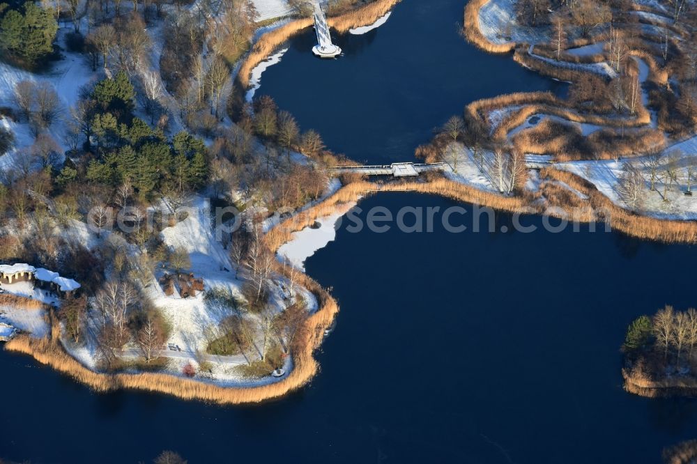 Berlin from above - Wintry snowy lake area of Hauptsee in the recreation park Britz Garden in Berlin, Germany