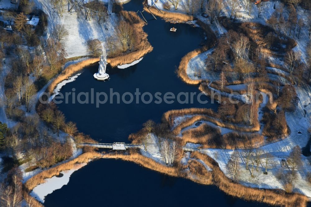 Berlin from the bird's eye view: Wintry snowy lake area of Hauptsee in the recreation park Britz Garden in Berlin, Germany