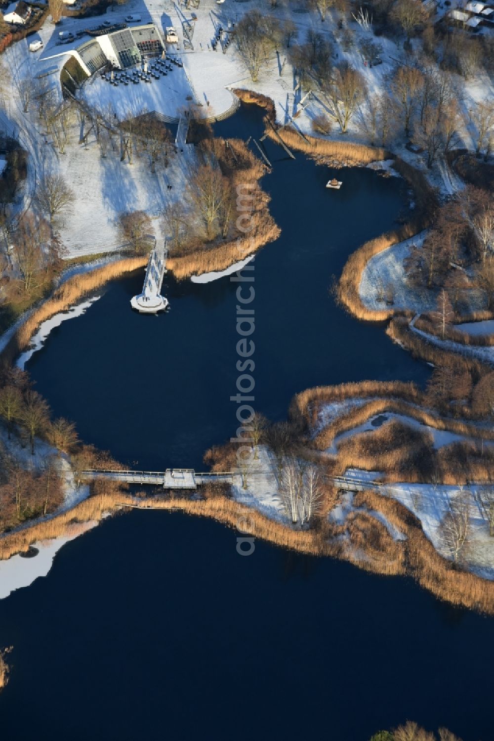 Aerial image Berlin - Wintry snowy lake area of Hauptsee in the recreation park Britz Garden in Berlin, Germany