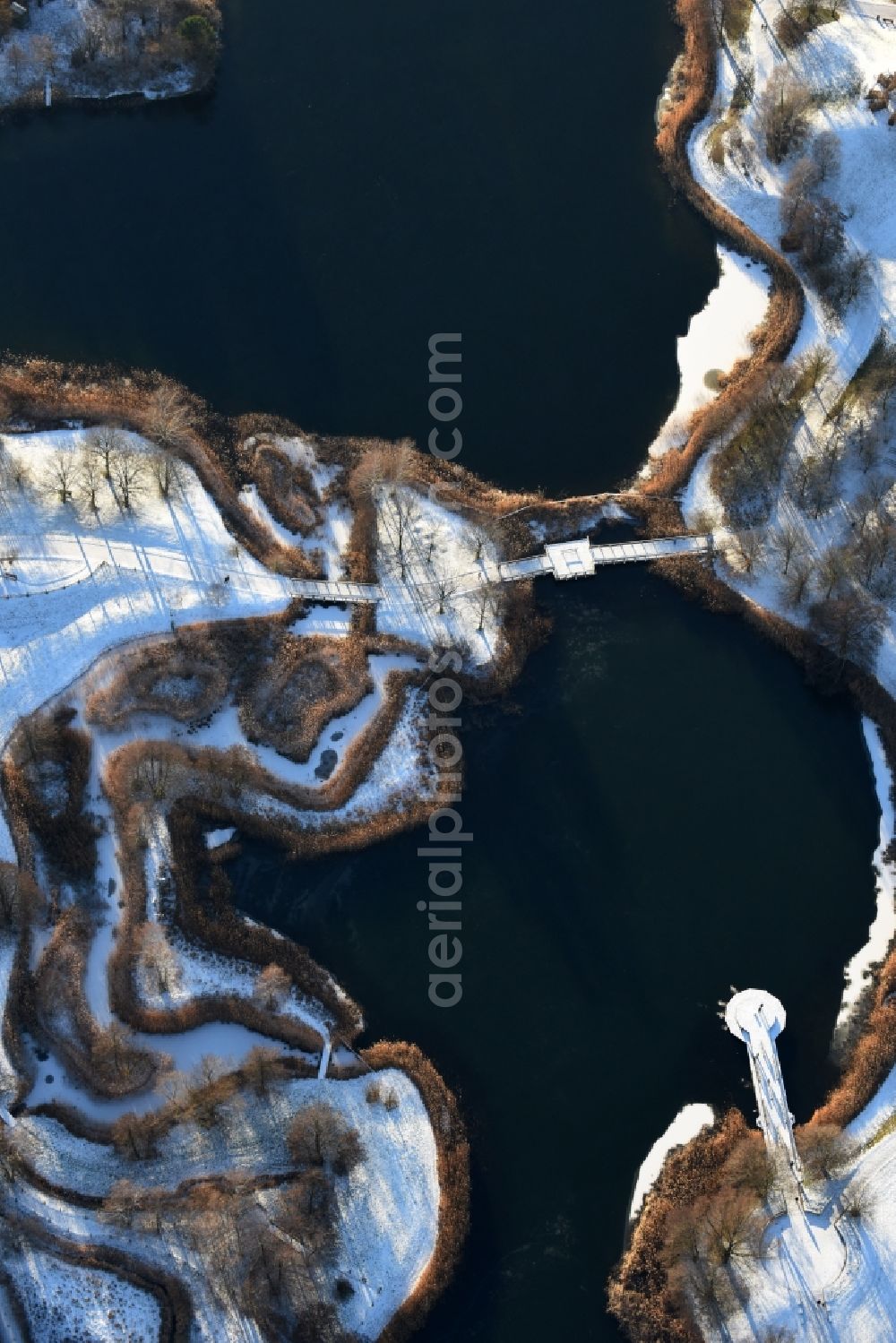 Berlin from the bird's eye view: Wintry snowy lake area of Hauptsee in the recreation park Britz Garden in Berlin, Germany